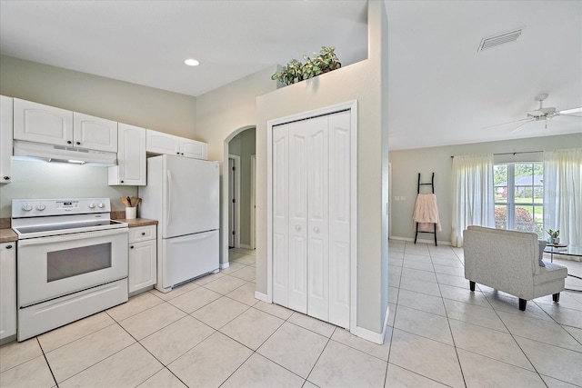 kitchen with light tile patterned flooring, white appliances, ceiling fan, and white cabinets