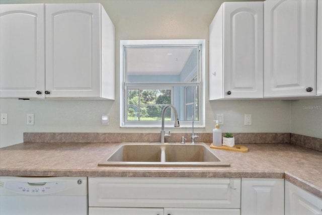 kitchen featuring dishwasher, sink, and white cabinets