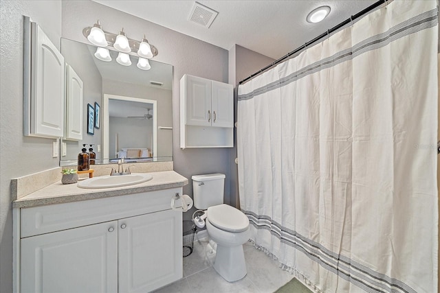 bathroom with toilet, a shower with curtain, a textured ceiling, vanity, and tile patterned flooring