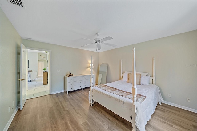 bedroom with ceiling fan and light hardwood / wood-style floors