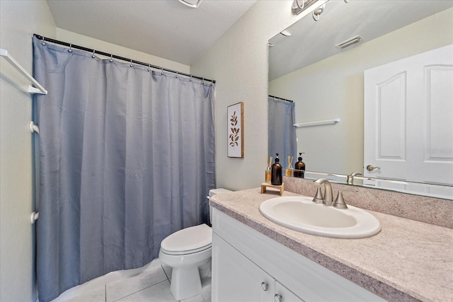 bathroom with vanity, tile patterned floors, and toilet