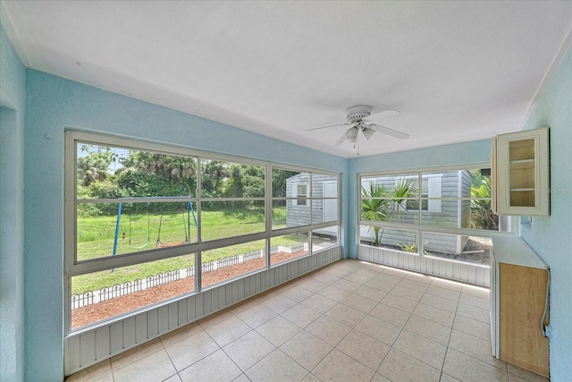 unfurnished sunroom featuring ceiling fan