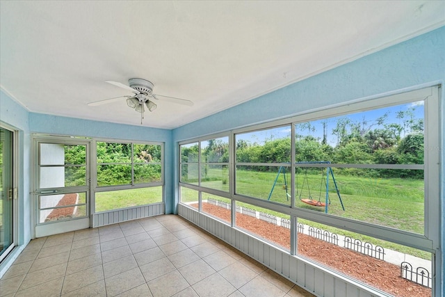 unfurnished sunroom featuring ceiling fan