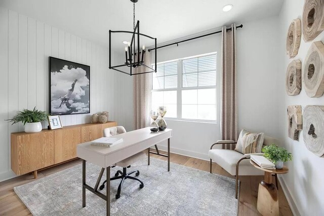 home office featuring an inviting chandelier and light hardwood / wood-style floors