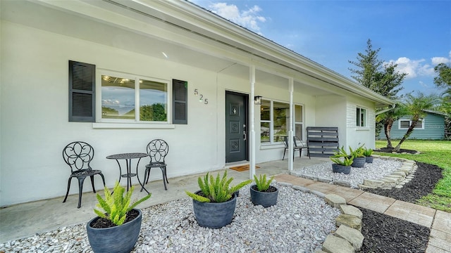 view of exterior entry featuring a porch