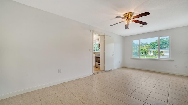 unfurnished room featuring light tile patterned floors and ceiling fan