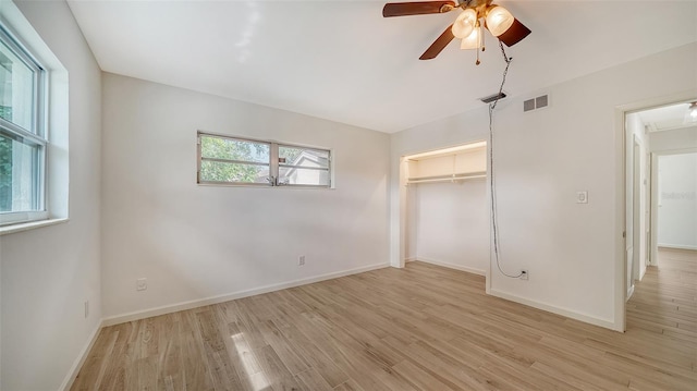 unfurnished bedroom with ceiling fan, light hardwood / wood-style flooring, and a closet