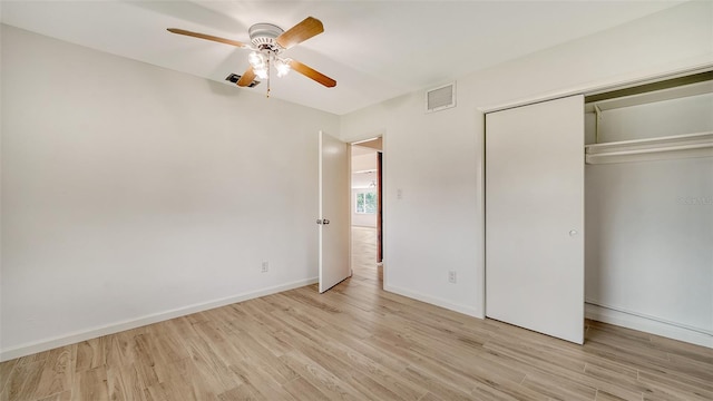 unfurnished bedroom with light hardwood / wood-style floors, a closet, and ceiling fan