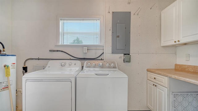 washroom featuring gas water heater, independent washer and dryer, electric panel, and cabinets