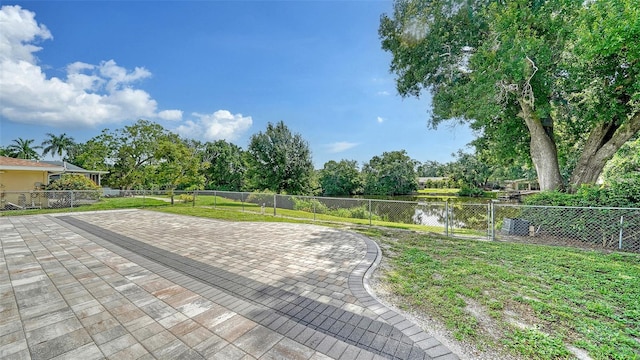 surrounding community with a patio, a water view, and a yard