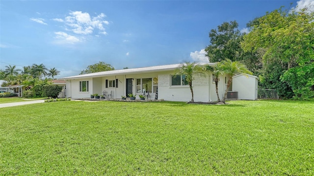 ranch-style home with a front lawn and cooling unit