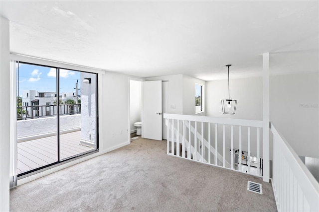 carpeted spare room with visible vents