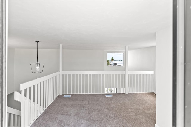 carpeted spare room with visible vents