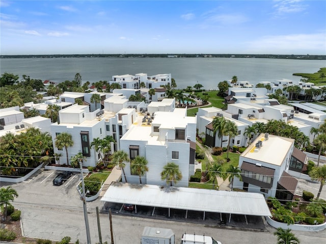 drone / aerial view with a residential view and a water view