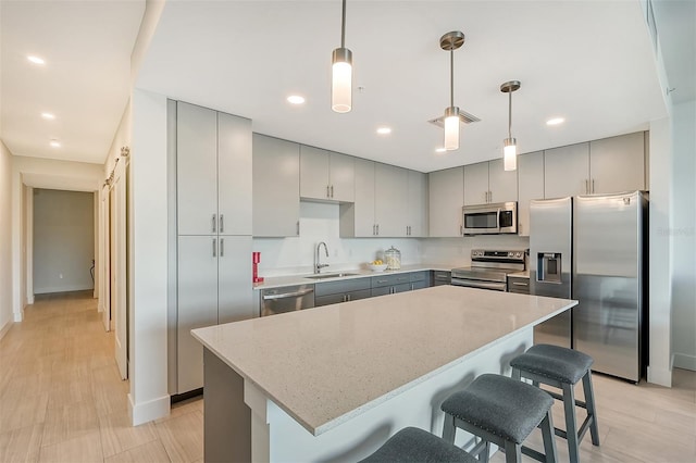 kitchen featuring appliances with stainless steel finishes, sink, and gray cabinetry