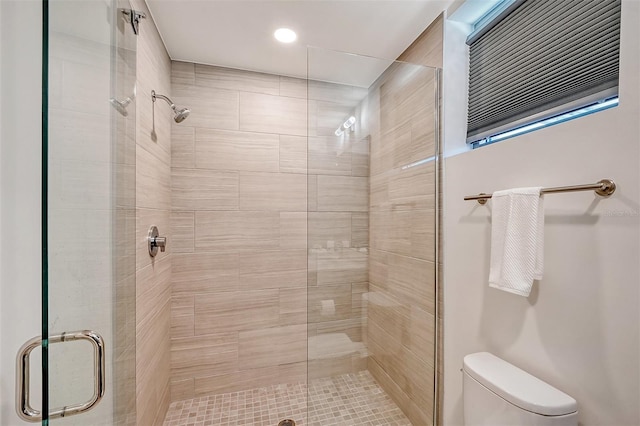 bathroom featuring walk in shower and toilet