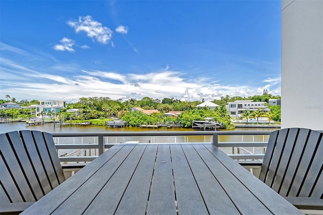 deck with a boat dock and a water view