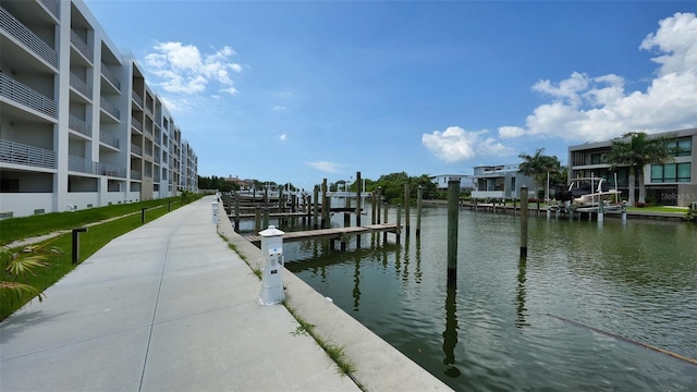 view of dock featuring a balcony and a water view