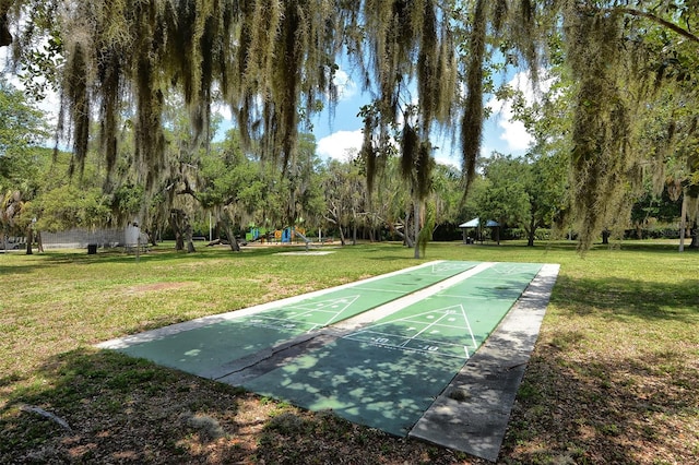 view of property's community featuring a lawn and a playground