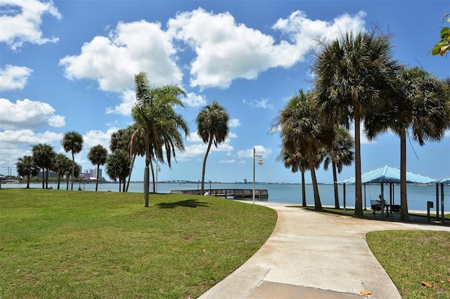 view of property's community with a gazebo, a water view, and a lawn