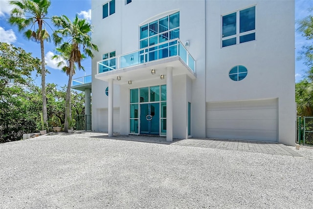 view of front of house featuring a balcony and a garage