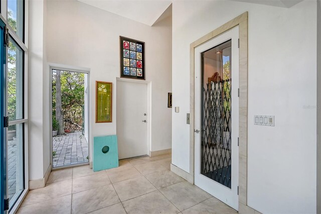 foyer entrance with light tile patterned floors