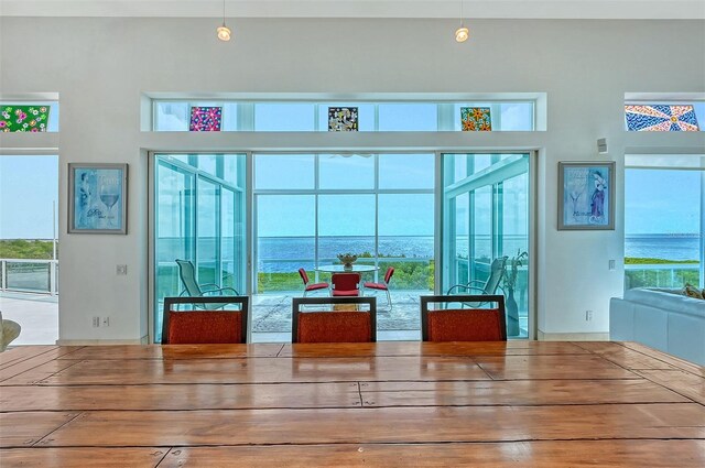 unfurnished dining area with a water view and a wealth of natural light