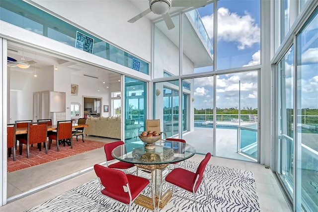 sunroom featuring ceiling fan