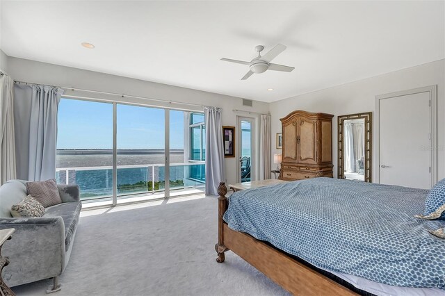 carpeted bedroom featuring a water view, ceiling fan, and access to exterior