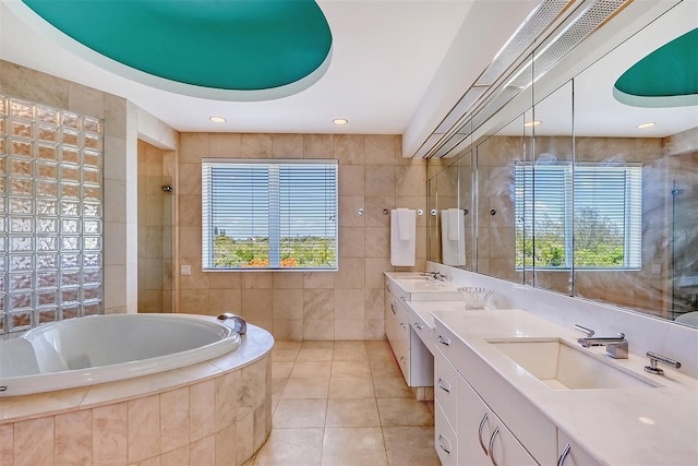 bathroom with shower with separate bathtub, tile walls, dual bowl vanity, and tile patterned flooring