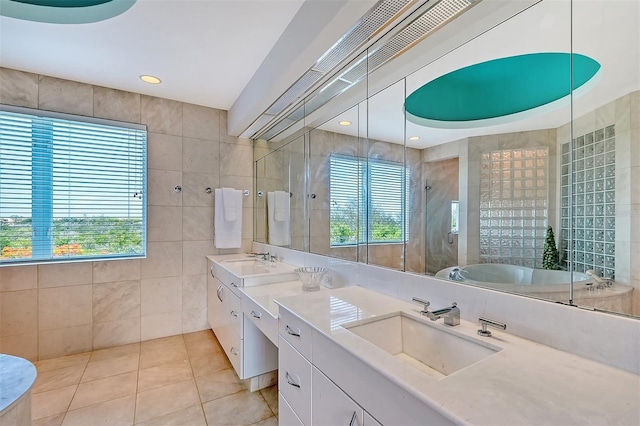 bathroom with tile walls, vanity, plenty of natural light, and tile patterned floors