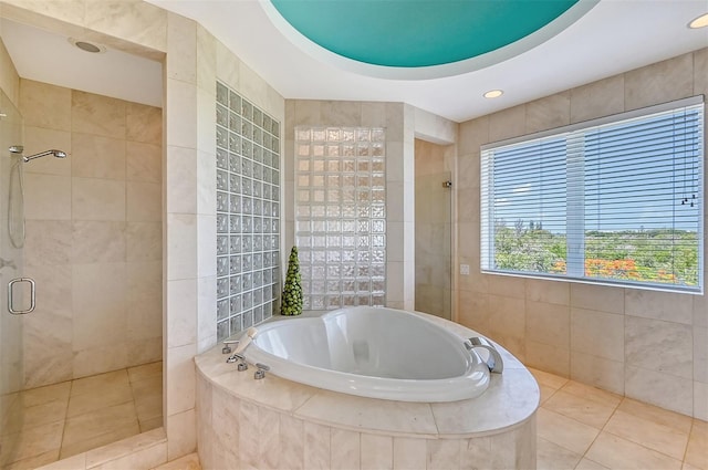 bathroom with tile patterned flooring and plus walk in shower