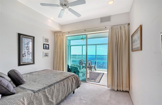 carpeted bedroom featuring a water view, access to outside, and ceiling fan