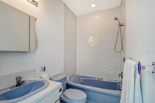 full bathroom with vanity, toilet, and tiled shower / bath