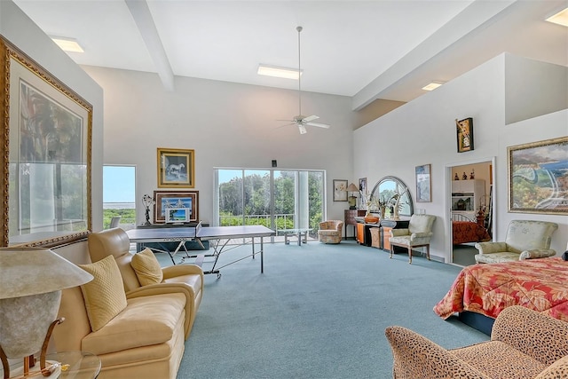 living room with carpet floors, a high ceiling, beamed ceiling, and ceiling fan