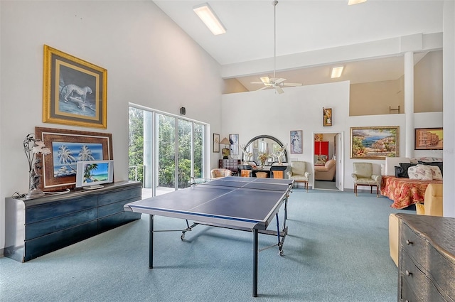 recreation room with high vaulted ceiling, ceiling fan, and carpet flooring