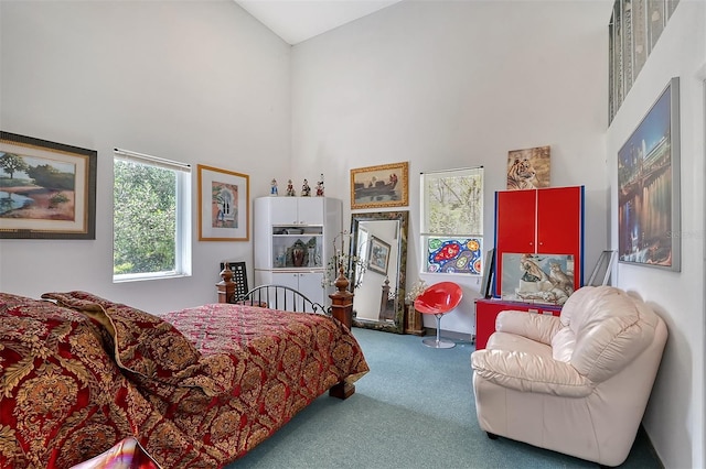 carpeted bedroom with a towering ceiling