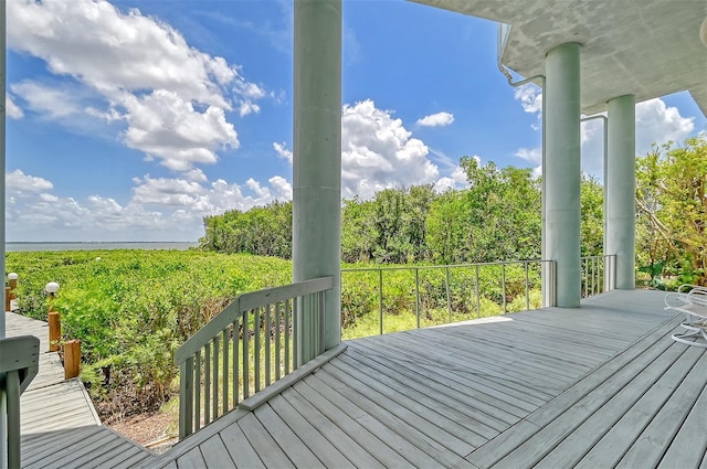 wooden terrace featuring a water view