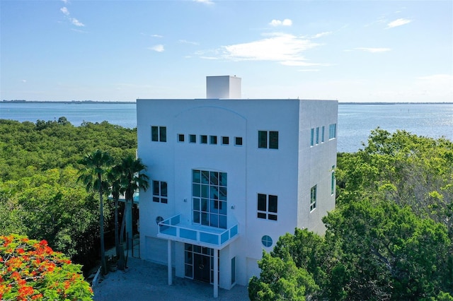 view of building exterior featuring a water view and a garage