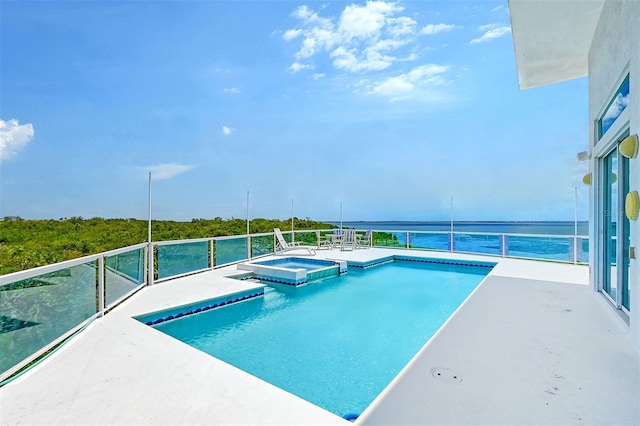 view of pool featuring an in ground hot tub and a water view