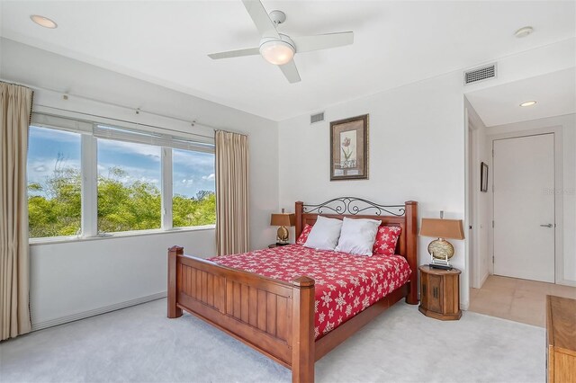 bedroom with light carpet and ceiling fan