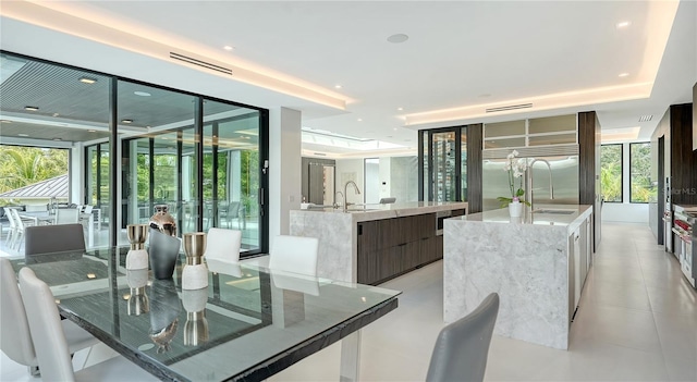 dining room featuring plenty of natural light, expansive windows, and sink