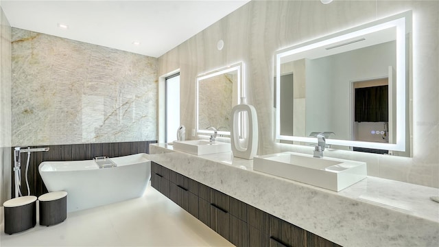 bathroom featuring a tub to relax in and vanity