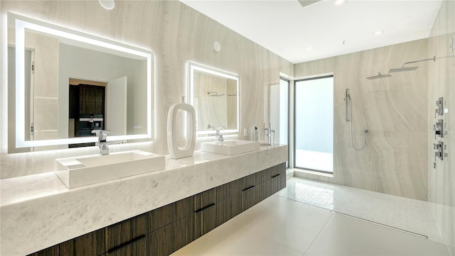 bathroom featuring vanity, tile patterned flooring, and walk in shower