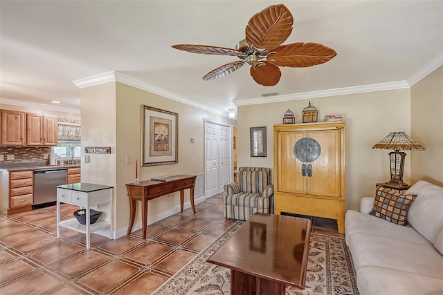 living room with ceiling fan and ornamental molding