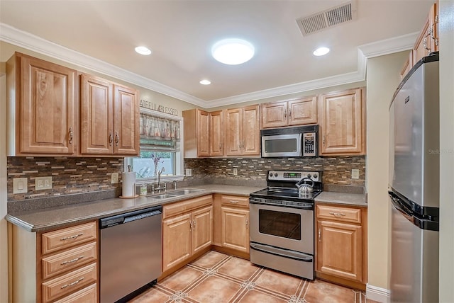 kitchen with light tile patterned flooring, sink, ornamental molding, and stainless steel appliances