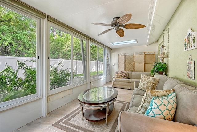 sunroom with a skylight and ceiling fan