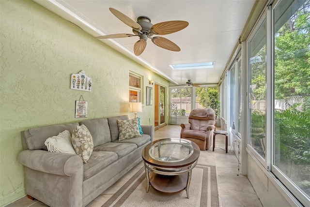 sunroom featuring a skylight and ceiling fan