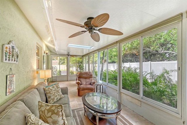 sunroom / solarium featuring ceiling fan and a skylight