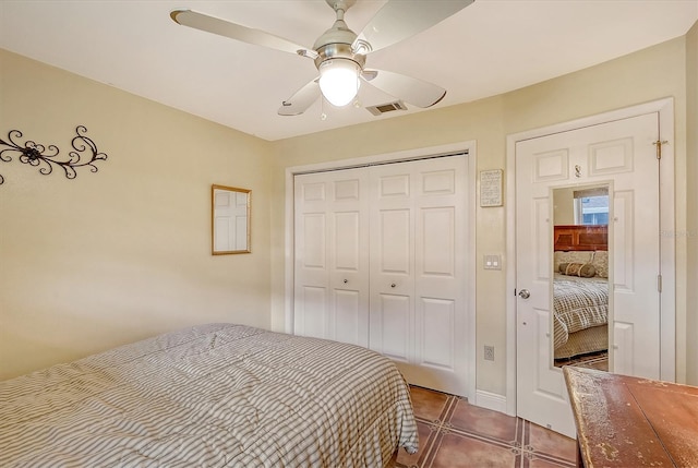 tiled bedroom featuring ceiling fan